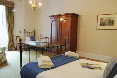 two twin beds in a room with at The Billiard Room Flat