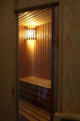 a door to a sauna with a light in it at The Billiard Room Flat