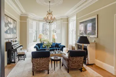 a living room with a couch and a table and a piano at Private and Prestigious Luxury Home in Edinburgh