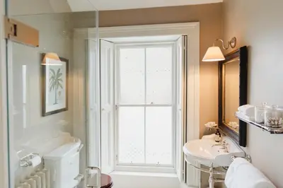 a bathroom with a white sink and a window at Private and Prestigious Luxury Home in Edinburgh