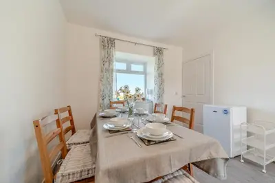a dining room with a table with plates and dishes on it at 3 Bed in Clachan oc-h32242 in Clachan