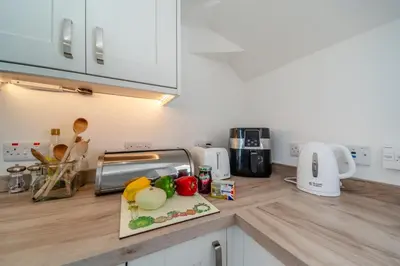 a kitchen counter with vegetables on a cutting board at 3 Bed in Clachan oc-h32242 in Clachan