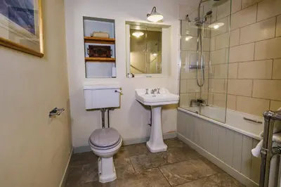 a bathroom with a toilet and a sink and a shower at Craigendarroch No 1 in Acharn