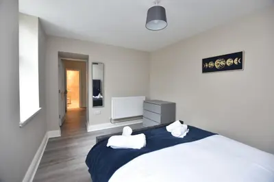 a bedroom with a bed with two towels on it at The Cliff Retreat in Wemyss Bay