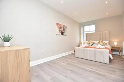 a bedroom with a large bed and a window at The Cliff Retreat in Wemyss Bay