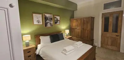 a bedroom with a bed with two towels on it at Cosy 2 bedroom flat-castle view in Edinburgh