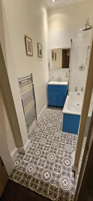 a bathroom with a sink and a toilet and a tub and a sink at Cosy 2 bedroom flat-castle view in Edinburgh
