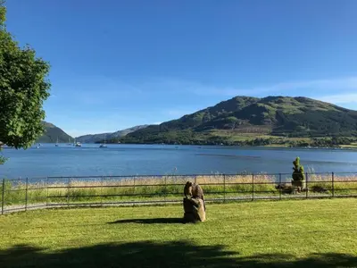 a couple of animals standing next to a body of water at The Shore House in Lochgoilhead