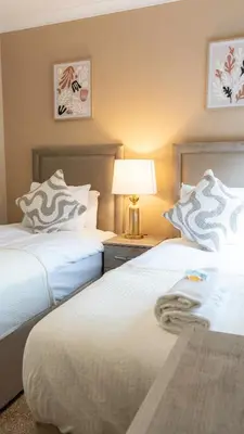 two beds sitting next to each other in a bedroom at Forbes House in Glasgow