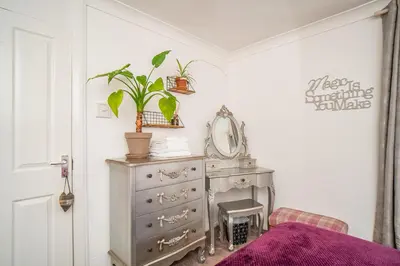 a bedroom with a dresser and a mirror at Edinburgh Pad in Edinburgh