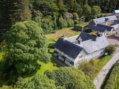 an overhead view of a large house with trees at Achranich House in Lochaline