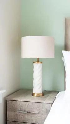 a lamp on a night stand next to a bed at Tummel Place in Grangemouth