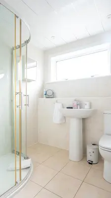 a bathroom with a toilet and a sink and a shower at Tummel Place in Grangemouth