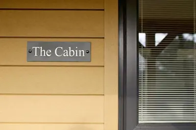 a sign on a door that reads the cattium at Newly built luxury cabin in Moffat