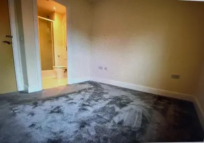 an empty room with a concrete floor and a hallway at Grebe House in Moffat