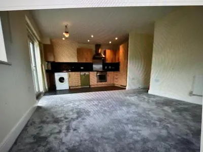 an empty room with a kitchen with a stove at Grebe House in Moffat