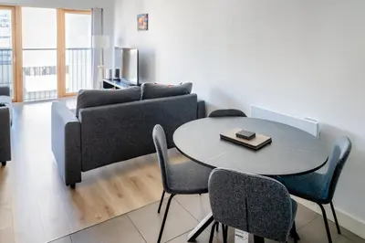 a living room with a table and a couch at Argyle Street Apartments in Glasgow