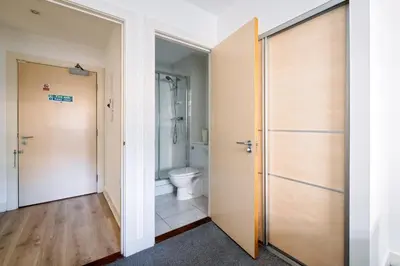 a bathroom with a toilet and a shower at Argyle Street Apartments in Glasgow