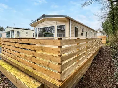a wooden fence in front of a house at Platinum in Newton Stewart