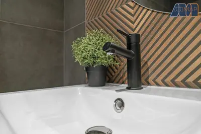 a bathroom sink with a faucet and a potted plant at Modern 2 Bed Sleep 4 In Gourock in Gourock