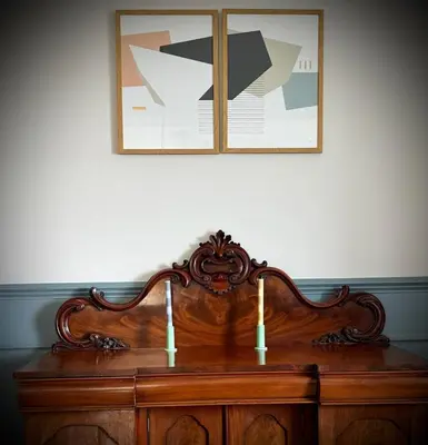 a wooden dresser with two candles on top of it at No 8 Lomond Castle in Luss