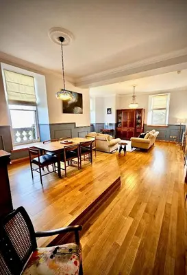 a large living room with a table and chairs at No 8 Lomond Castle in Luss