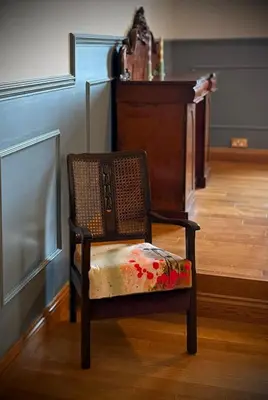 a chair with a floral seat in a room at No 8 Lomond Castle in Luss