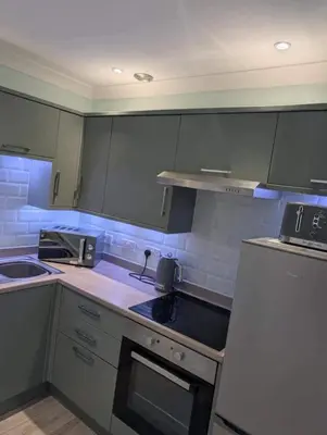a small kitchen with a stove and a sink at Largs seaside retreat in Largs