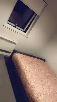 a bed in a small room with a window at Casa da Paz in Glasgow