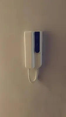 a phone is hanging on a wall at Casa da Paz in Glasgow