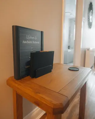 a television sitting on top of a wooden table at Anchors Retreat in Ayr