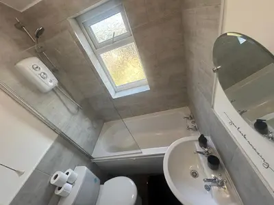 a bathroom with a sink and a toilet and a mirror at HULL 2BED Sleeps 4 BETTO Cosy Home! in Moffat