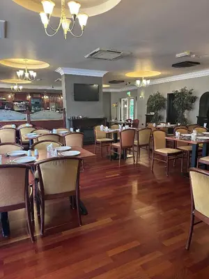 a dining room with tables and chairs in a restaurant at The Villa Hamilton in Hamilton