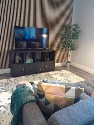 a living room with a couch and a flat screen tv at Outlander 4 Apartment Doune in Stirling