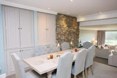 a dining room with a table and chairs at 5 Bed Family Home Lochwinnoch in Lochwinnoch