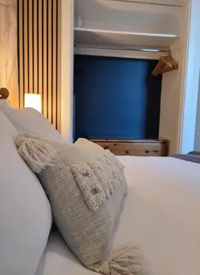 a white pillow sitting on top of a bed at Peaceful Edinburgh Retreat - Quiet Central 1-Bed in Edinburgh