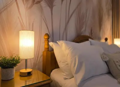 a bedroom with a bed with a table with a lamp at Peaceful Edinburgh Retreat - Quiet Central 1-Bed in Edinburgh