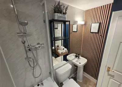 a bathroom with a shower and a toilet and a sink at Peaceful Edinburgh Retreat - Quiet Central 1-Bed in Edinburgh