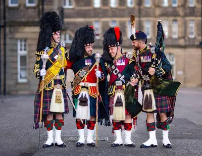 a group of men in kilts standing in front of a building at Peaceful Edinburgh Retreat - Quiet Central 1-Bed in Edinburgh