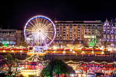 a large ferris wheel in a city at night at Peaceful Edinburgh Retreat - Quiet Central 1-Bed in Edinburgh