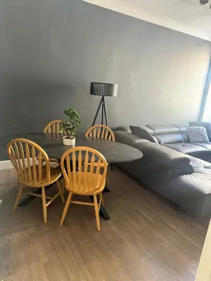 a living room with a table and chairs and a couch at Fountain park get away one bedroom in a 2 bedroom apartment in Edinburgh