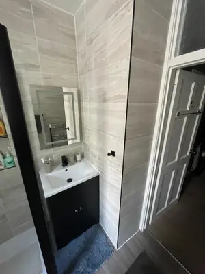 a bathroom with a sink and a mirror at Fountain park get away one bedroom in a 2 bedroom apartment in Edinburgh