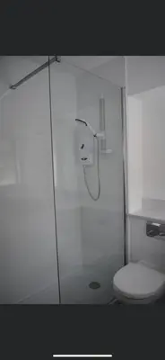 a bathroom with a glass shower with a toilet at Rowardennan Rooms in the lodge Lodge no 2 in Rowardennan