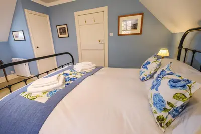 a bedroom with a bed with towels on it at Craigendarroch No 2 in Acharn