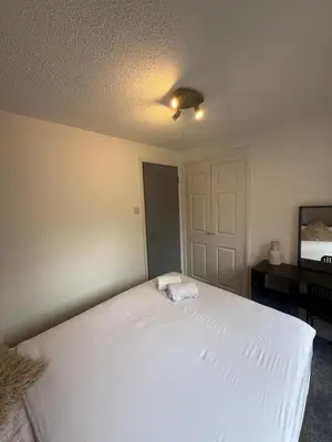 a bedroom with a large white bed with a ceiling at City Centre 2 Bed Apartment in Glasgow