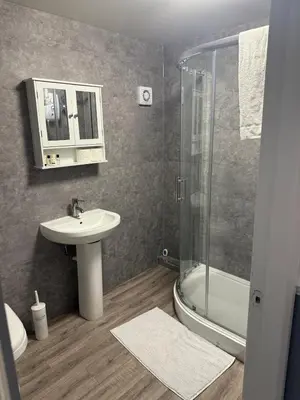 a bathroom with a sink and a shower at City Centre 2 Bed Apartment in Glasgow