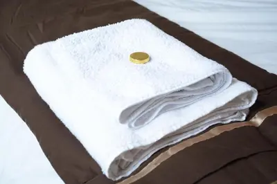 a pile of white towels sitting on top of a table at Townhead Apartments Glasgow Airport in Paisley