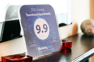 a sign sitting on top of a table at Townhead Apartments Glasgow Airport in Paisley