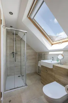 a bathroom with a shower and a toilet and a skylight at Dalnahua on 'The Secret Coast'