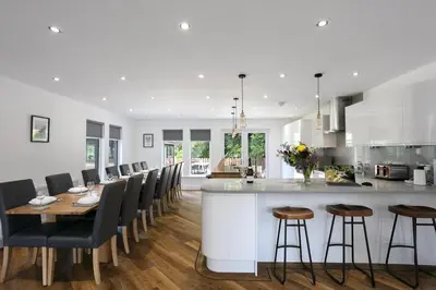 a kitchen and dining room with a bar and chairs at Dalnahua on 'The Secret Coast'